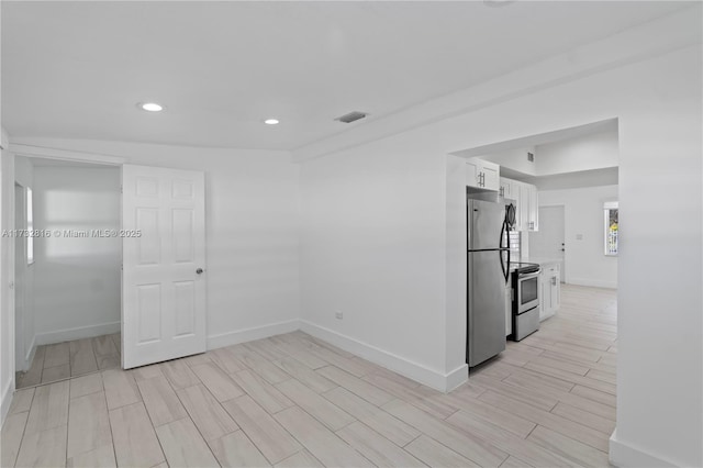 kitchen with stainless steel appliances and white cabinetry