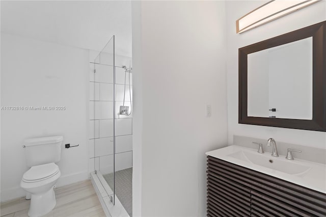 bathroom featuring walk in shower, vanity, and toilet