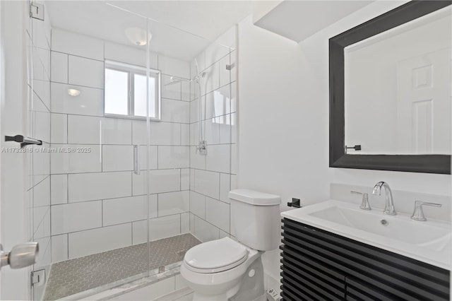 bathroom with a shower with door, vanity, and toilet