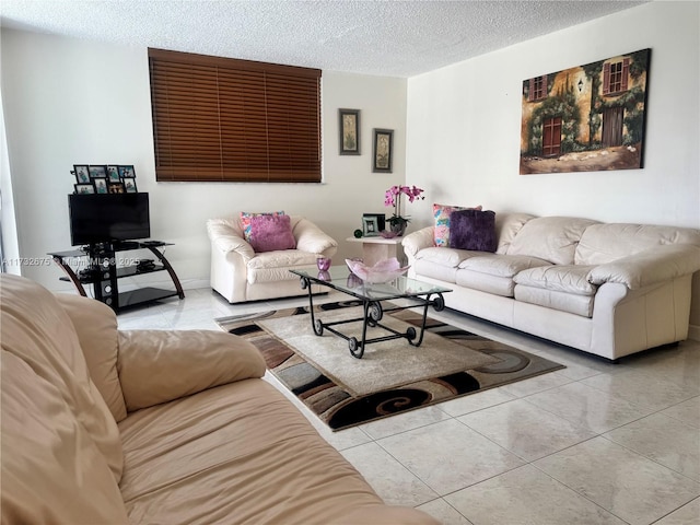 tiled living room featuring a textured ceiling