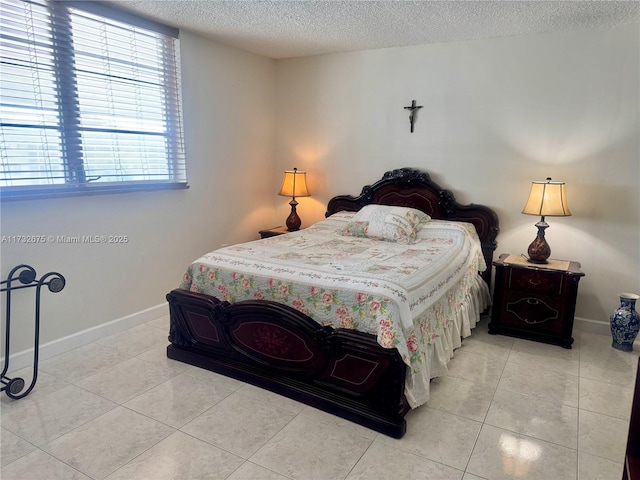 bedroom featuring light tile patterned floors and a textured ceiling