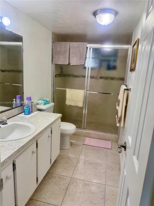 bathroom with vanity, an enclosed shower, tile patterned floors, and toilet