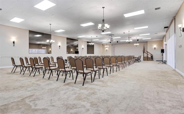 miscellaneous room featuring an inviting chandelier and light carpet