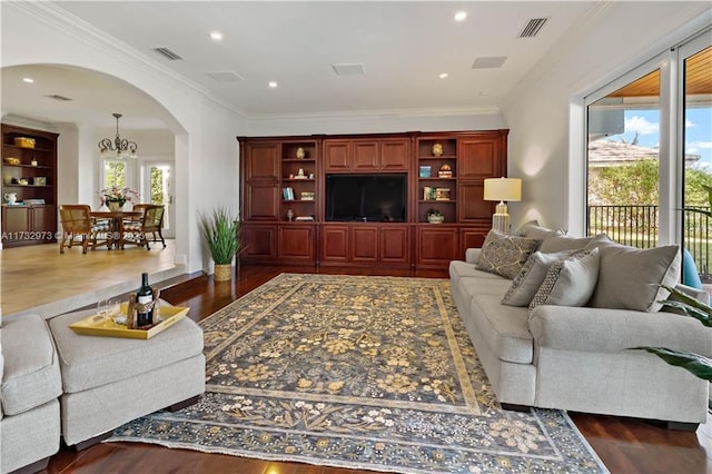 living room featuring crown molding, visible vents, arched walkways, and dark wood-style flooring