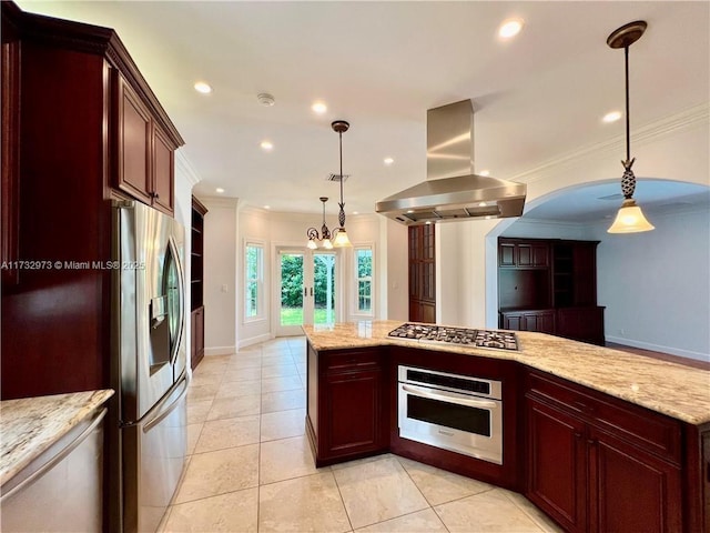 kitchen with stainless steel appliances, reddish brown cabinets, island exhaust hood, decorative light fixtures, and crown molding