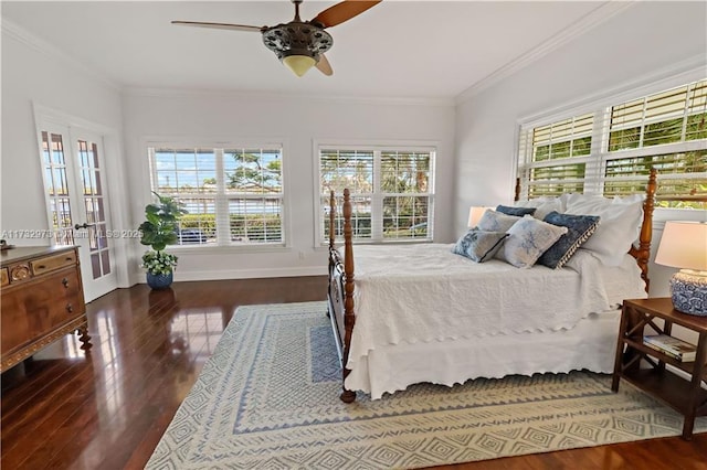 bedroom featuring ornamental molding, multiple windows, and wood finished floors