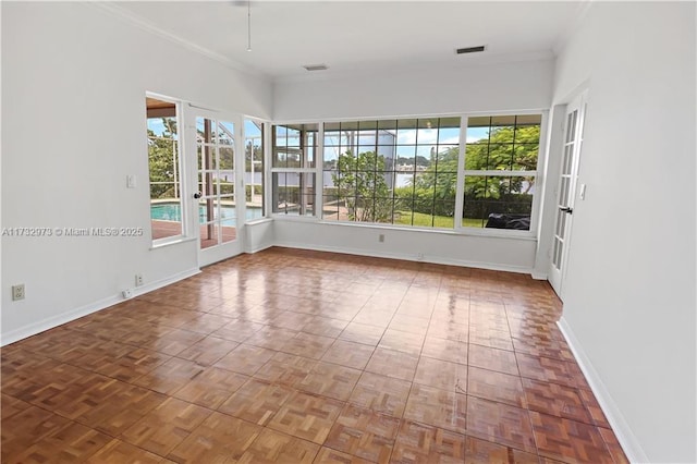 unfurnished sunroom featuring visible vents and a wealth of natural light