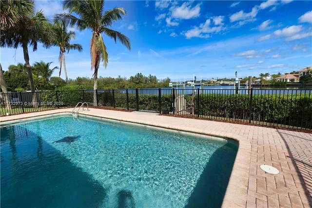 pool featuring a water view and fence