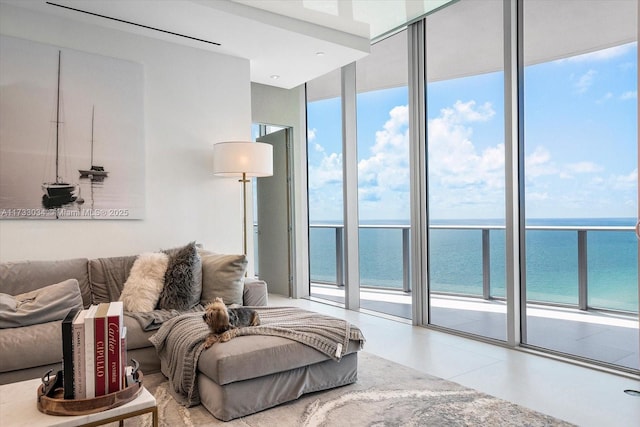 living room featuring floor to ceiling windows and a water view