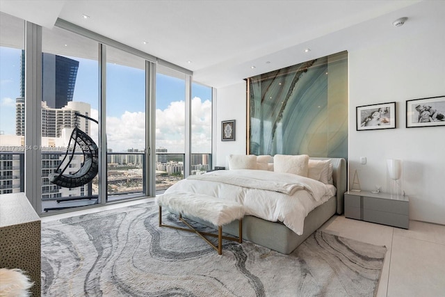 bedroom featuring multiple windows, access to outside, and floor to ceiling windows