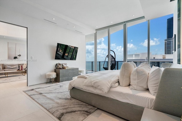 bedroom featuring light tile patterned floors and a wall of windows