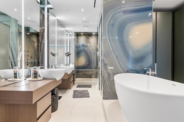 bathroom featuring vanity, a tub to relax in, and tile patterned floors