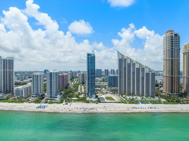 exterior space with a water view and a beach view