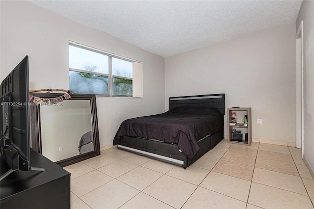 tiled bedroom featuring a textured ceiling