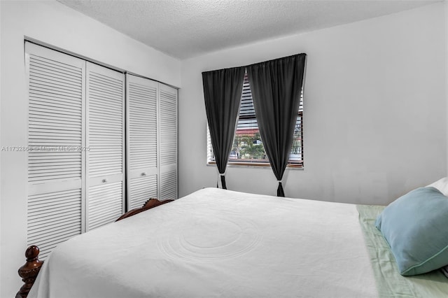 bedroom with a closet and a textured ceiling