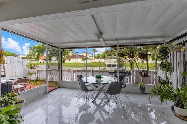 sunroom / solarium with a water view