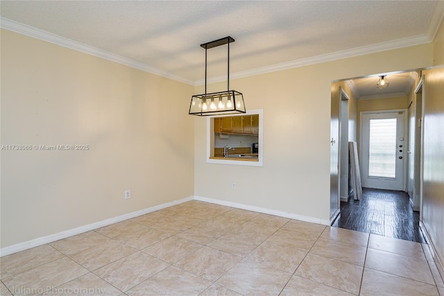 empty room featuring ornamental molding, a textured ceiling, and light tile patterned flooring