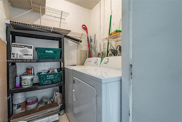 clothes washing area featuring washer and clothes dryer