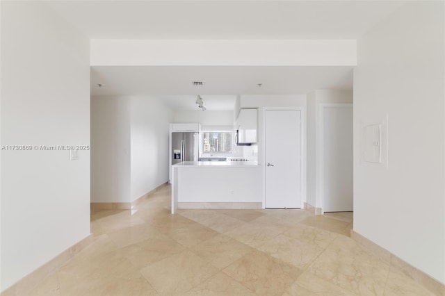 unfurnished living room featuring marble finish floor, visible vents, and baseboards