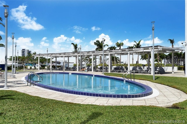 community pool with a lawn and a pergola