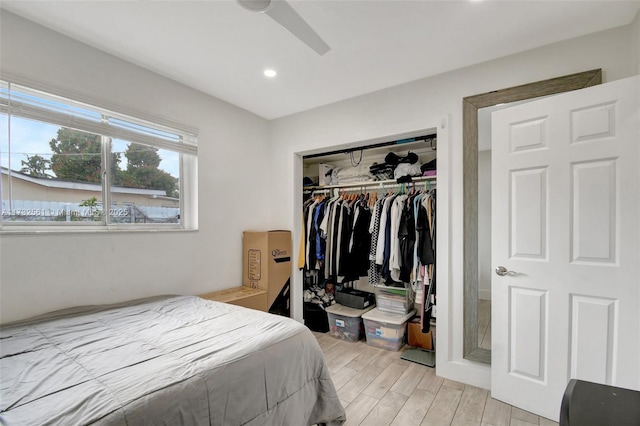 bedroom with light hardwood / wood-style flooring, a closet, and ceiling fan