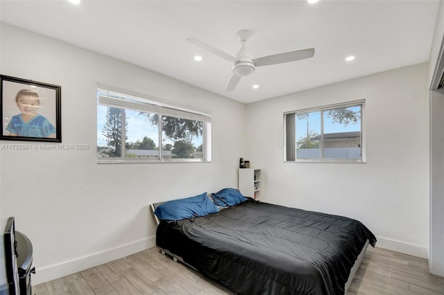 bedroom with ceiling fan and light hardwood / wood-style floors