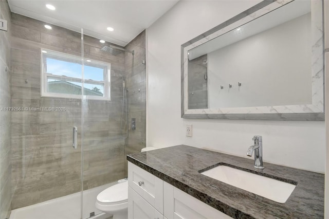 bathroom with vanity, toilet, and walk in shower