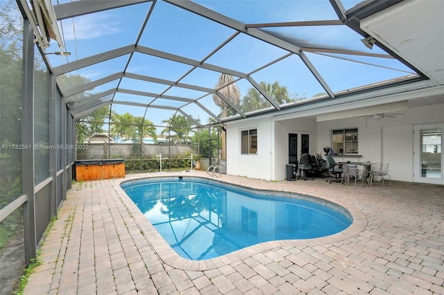 view of pool featuring ceiling fan, a hot tub, a patio, and a lanai