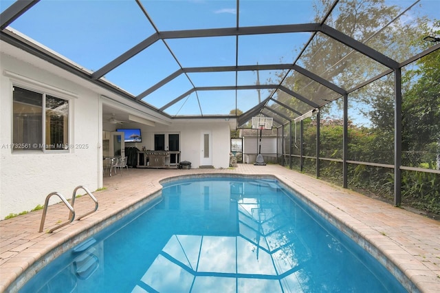 view of pool with a lanai, ceiling fan, and a patio area