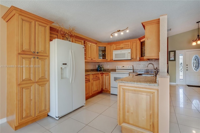 kitchen with light tile patterned flooring, sink, light stone counters, pendant lighting, and white appliances