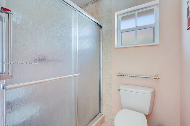 bathroom with walk in shower and toilet