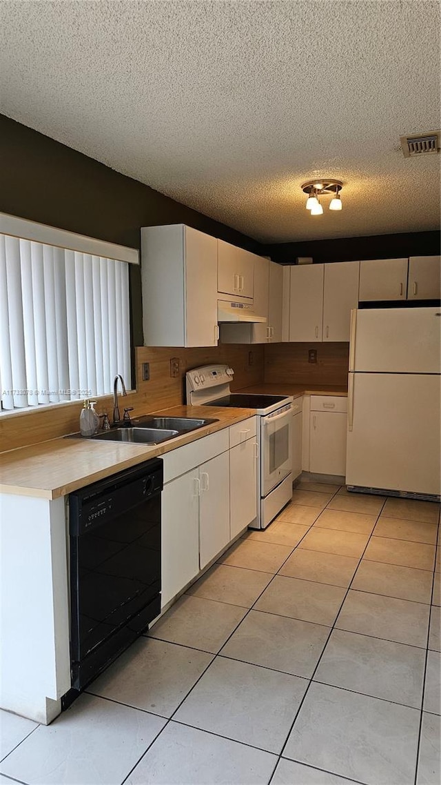 kitchen featuring white cabinetry, a textured ceiling, and white appliances