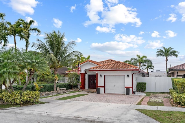 mediterranean / spanish-style house with a garage