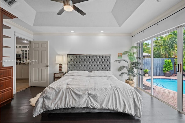 bedroom featuring access to exterior, ceiling fan, a tray ceiling, crown molding, and dark wood-type flooring