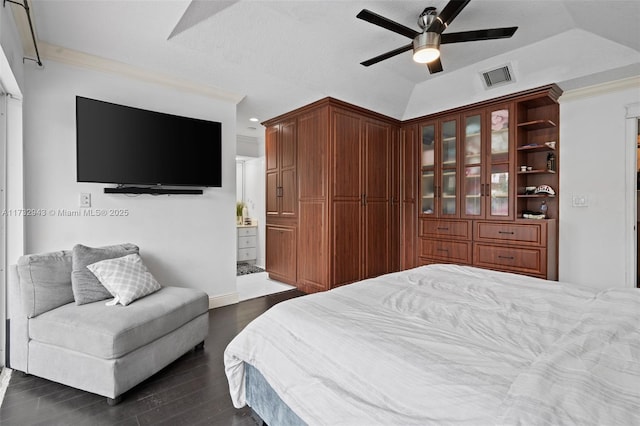 bedroom with ensuite bathroom, lofted ceiling, ornamental molding, ceiling fan, and dark wood-type flooring