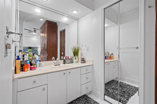 bathroom with tile patterned flooring, vanity, a textured ceiling, and ceiling fan