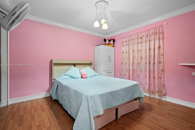 bedroom featuring hardwood / wood-style flooring, crown molding, and a textured ceiling