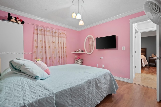 bedroom featuring crown molding, a textured ceiling, and hardwood / wood-style flooring