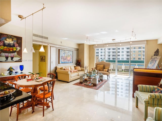 tiled dining space featuring a wall of windows