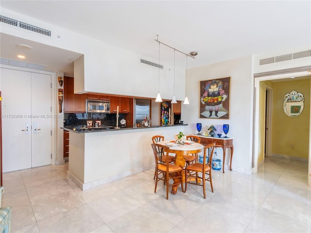 dining area with track lighting and light tile patterned floors