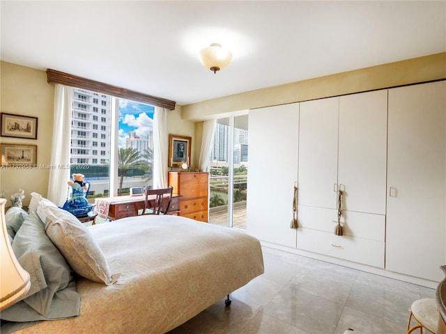 bedroom with multiple windows, access to outside, and floor to ceiling windows