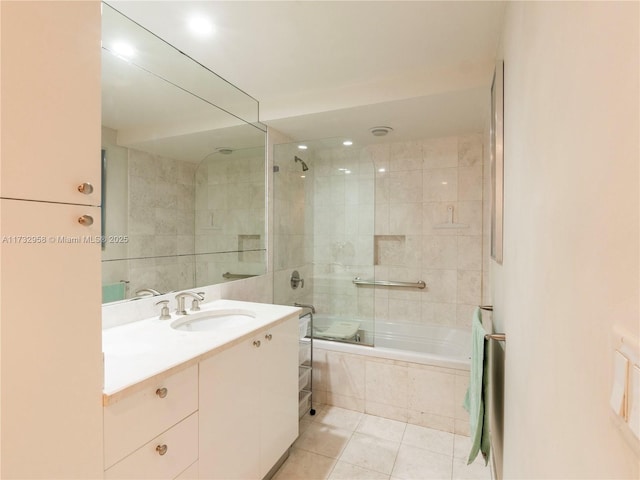 bathroom with vanity, tiled shower / bath combo, and tile patterned flooring