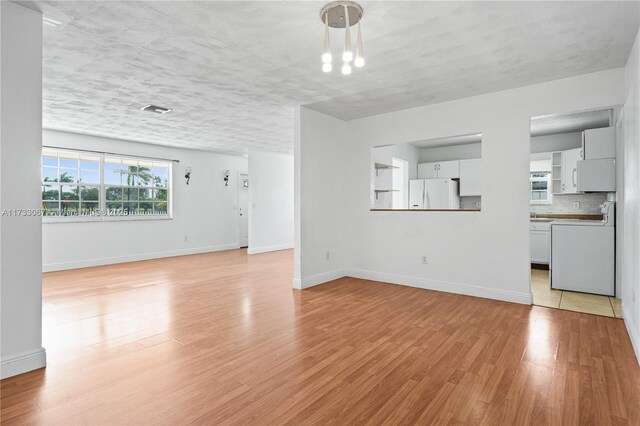 living room with ceiling fan, wood-type flooring, and a textured ceiling