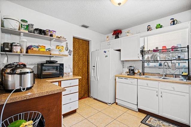 kitchen featuring white cabinetry, sink, white appliances, and a textured ceiling