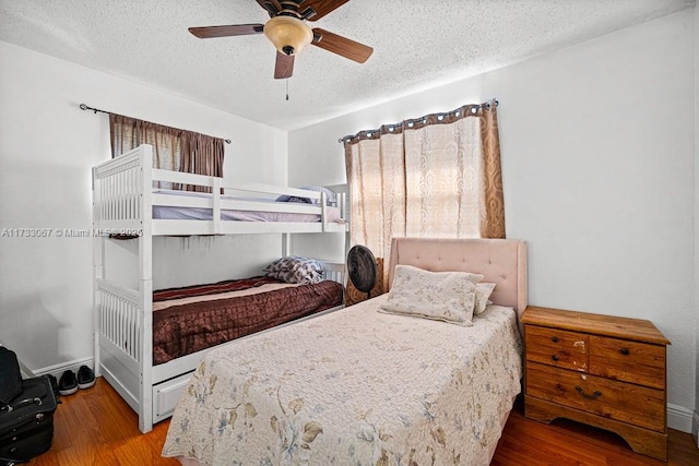 bedroom featuring hardwood / wood-style flooring, a textured ceiling, and ceiling fan