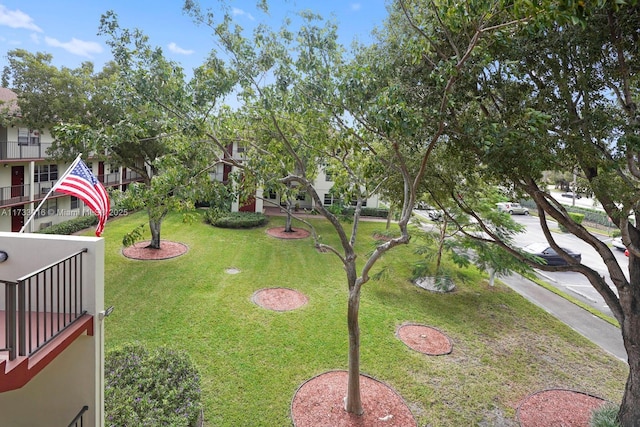 view of yard with a balcony