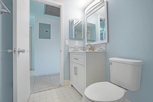 bathroom with toilet, vanity, electric panel, tile patterned flooring, and decorative backsplash