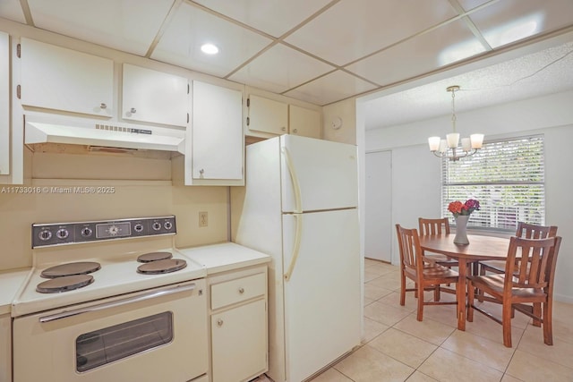 kitchen with a paneled ceiling, decorative light fixtures, light tile patterned floors, a notable chandelier, and white appliances