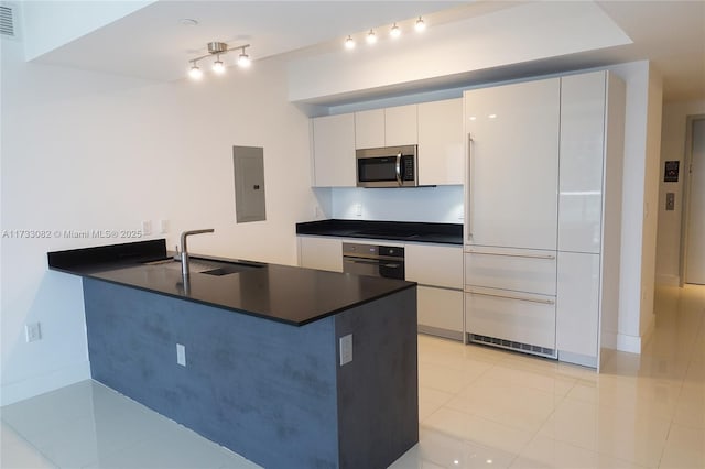 kitchen with black appliances, white cabinetry, sink, electric panel, and kitchen peninsula