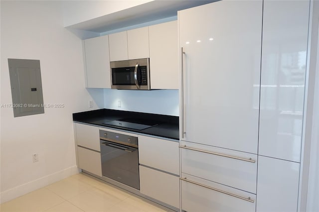 kitchen featuring light tile patterned floors, black appliances, white cabinets, and electric panel